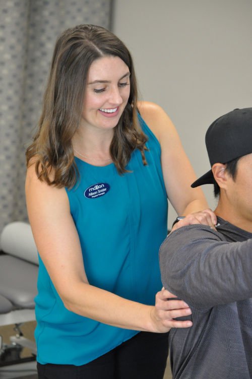 Physical therapist working on shoulder