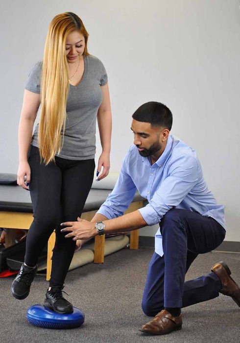 physical therapist working on a knee
