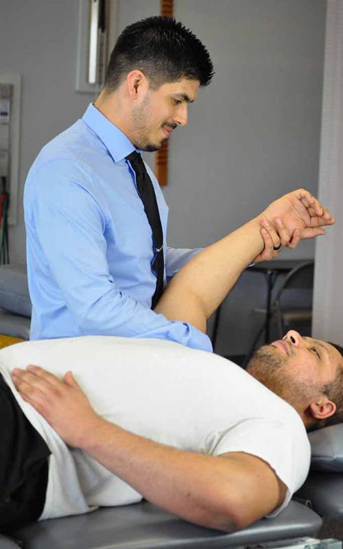 physical therapist working on a shoulder