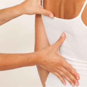 physical therapist examining a mid back