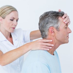 physical therapist examining a neck