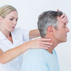 physical therapist examining a neck