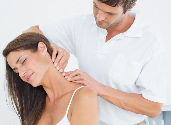 physical therapist working on woman with neck pain