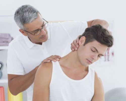 physical therapist working on man with neck pain